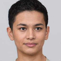 Joyful latino young-adult male with short  brown hair and brown eyes