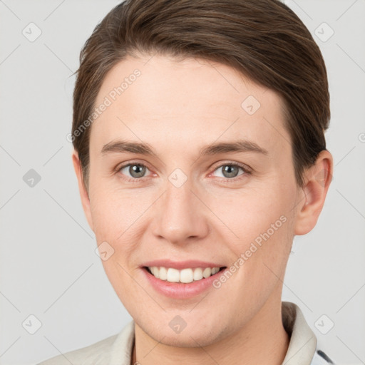 Joyful white young-adult female with short  brown hair and grey eyes