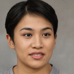 Joyful asian young-adult female with short  brown hair and brown eyes