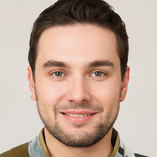 Joyful white young-adult male with short  brown hair and brown eyes