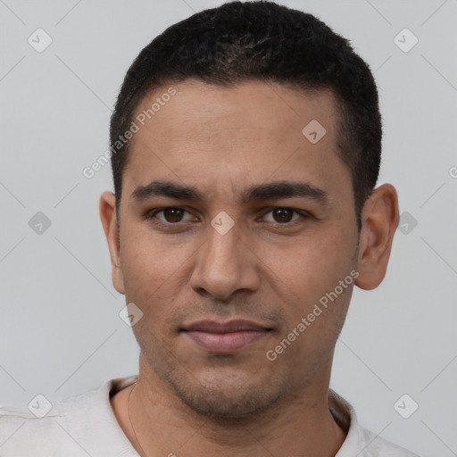 Joyful latino young-adult male with short  black hair and brown eyes