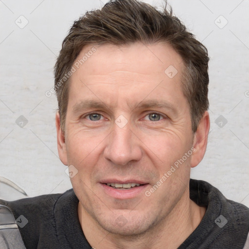 Joyful white adult male with short  brown hair and grey eyes