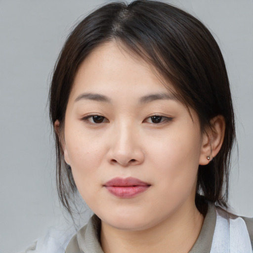 Joyful asian young-adult female with medium  brown hair and brown eyes