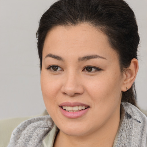 Joyful latino young-adult female with short  brown hair and brown eyes