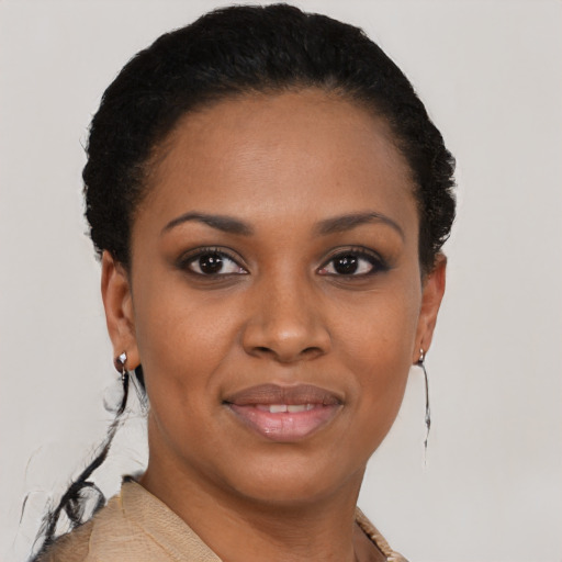 Joyful black young-adult female with short  black hair and brown eyes