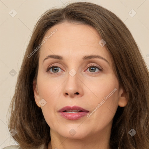 Joyful white adult female with long  brown hair and brown eyes