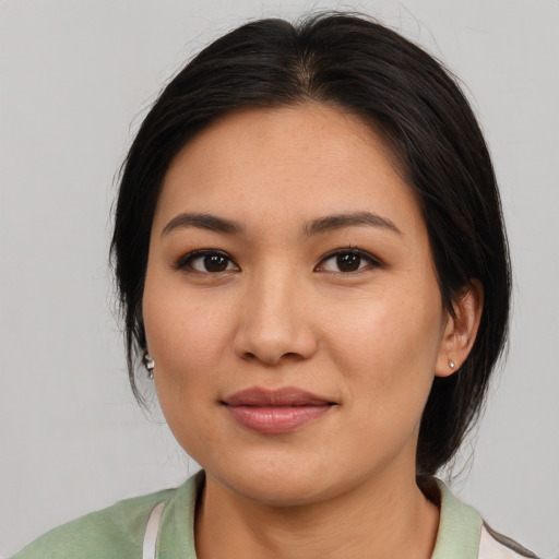 Joyful asian young-adult female with medium  brown hair and brown eyes