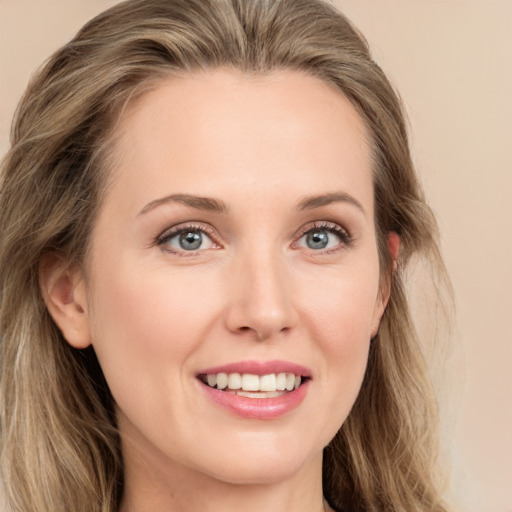 Joyful white young-adult female with long  brown hair and grey eyes