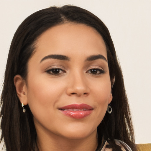 Joyful latino young-adult female with long  brown hair and brown eyes