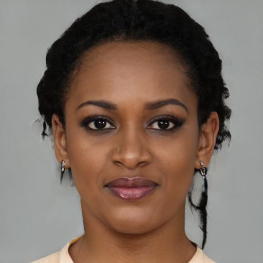 Joyful black young-adult female with medium  black hair and brown eyes