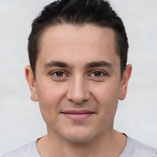 Joyful white young-adult male with short  brown hair and brown eyes