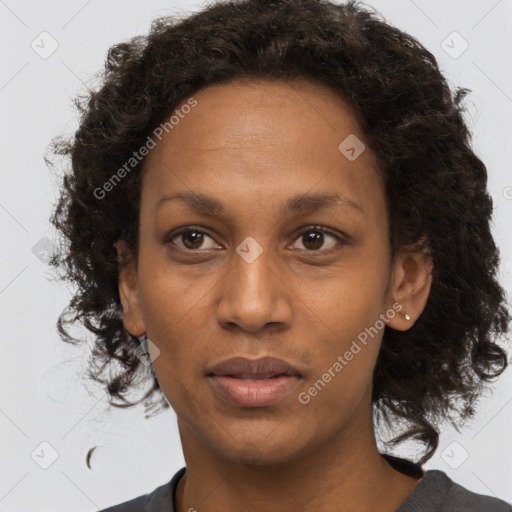 Joyful black adult female with medium  brown hair and brown eyes