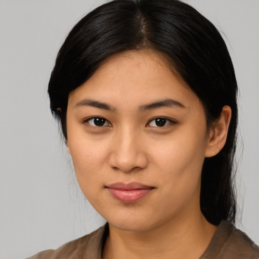 Joyful asian young-adult female with long  black hair and brown eyes