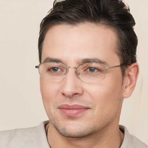 Joyful white adult male with short  brown hair and brown eyes