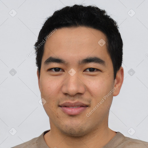 Joyful asian young-adult male with short  black hair and brown eyes