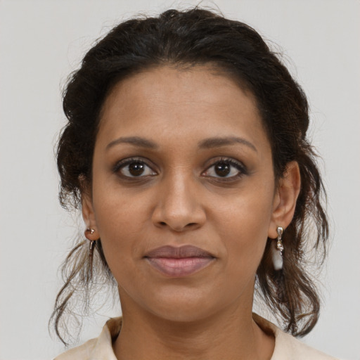 Joyful black young-adult female with medium  brown hair and brown eyes