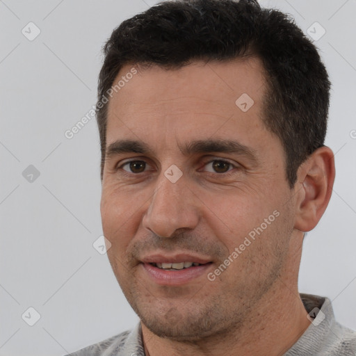 Joyful white adult male with short  black hair and brown eyes