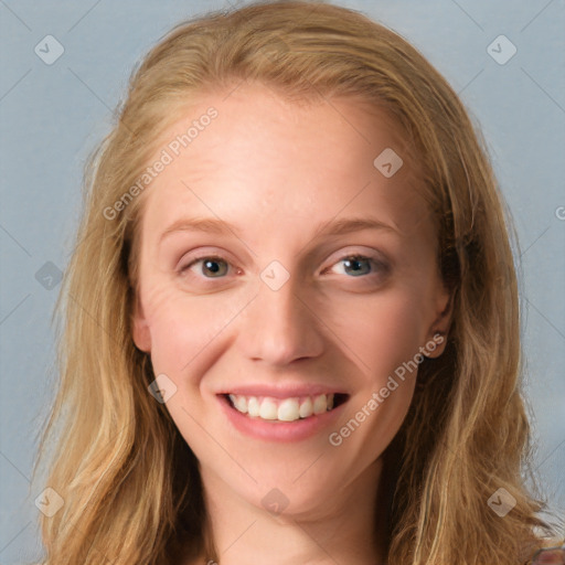 Joyful white young-adult female with long  brown hair and blue eyes