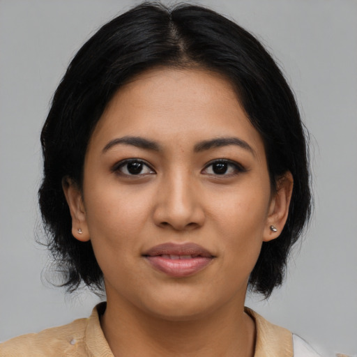 Joyful latino young-adult female with medium  black hair and brown eyes