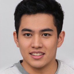 Joyful asian young-adult male with short  brown hair and brown eyes