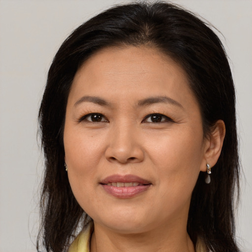 Joyful asian adult female with long  brown hair and brown eyes