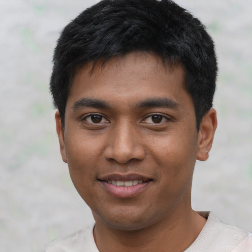 Joyful asian young-adult male with short  black hair and brown eyes