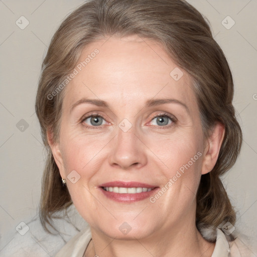 Joyful white adult female with medium  brown hair and grey eyes