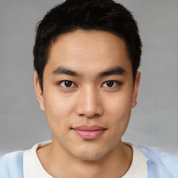 Joyful asian young-adult male with short  black hair and brown eyes