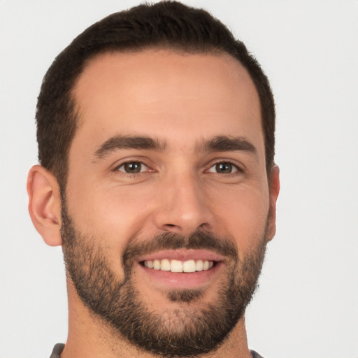 Joyful white young-adult male with short  brown hair and brown eyes