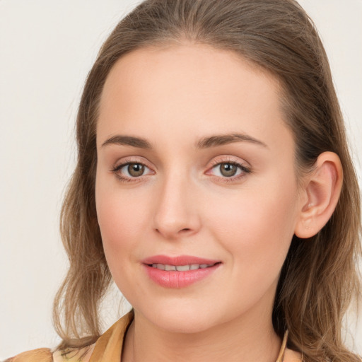 Joyful white young-adult female with long  brown hair and blue eyes