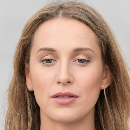 Joyful white young-adult female with long  brown hair and grey eyes