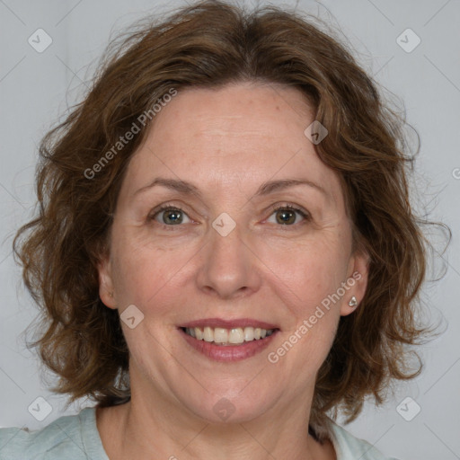 Joyful white adult female with medium  brown hair and blue eyes