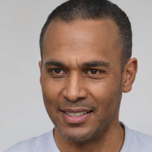 Joyful latino adult male with short  black hair and brown eyes