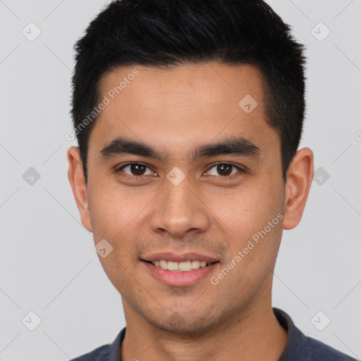 Joyful white young-adult male with short  black hair and brown eyes