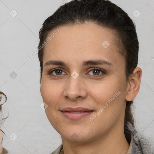 Joyful white young-adult female with medium  brown hair and brown eyes