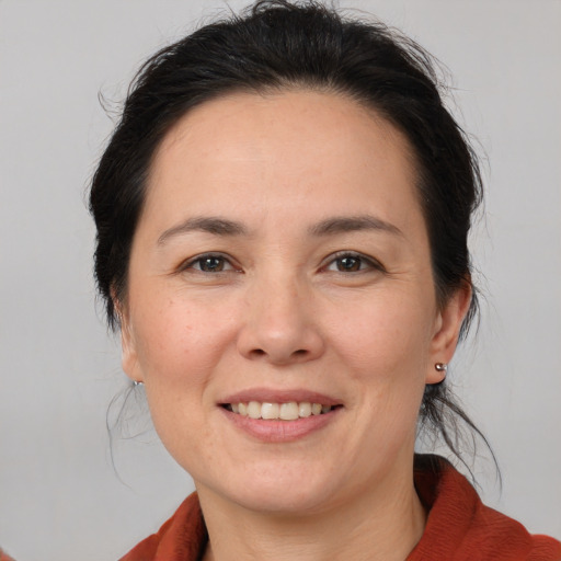 Joyful white adult female with medium  brown hair and brown eyes