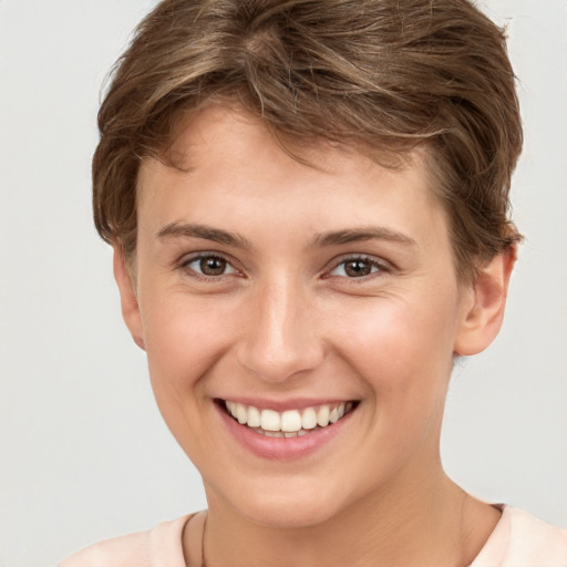 Joyful white young-adult female with short  brown hair and grey eyes