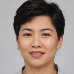 Joyful asian young-adult female with short  brown hair and brown eyes