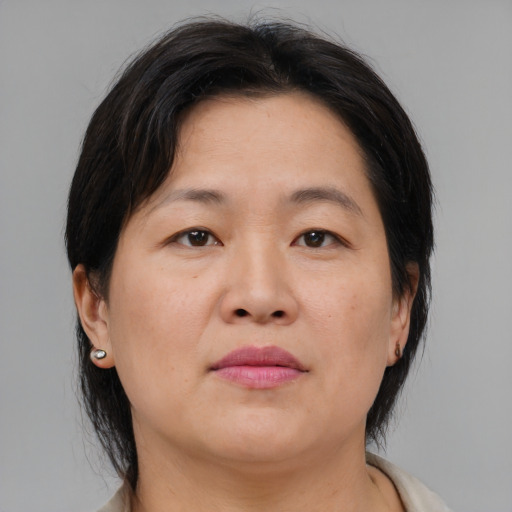 Neutral asian adult female with medium  brown hair and brown eyes