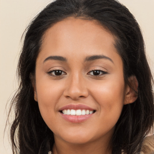 Joyful white young-adult female with long  brown hair and brown eyes