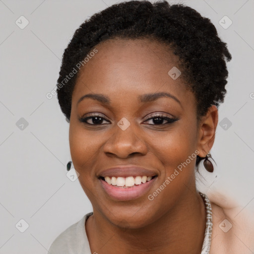 Joyful black young-adult female with short  brown hair and brown eyes