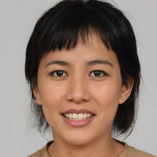Joyful asian young-adult female with medium  brown hair and brown eyes