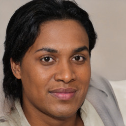 Joyful black young-adult female with medium  brown hair and brown eyes