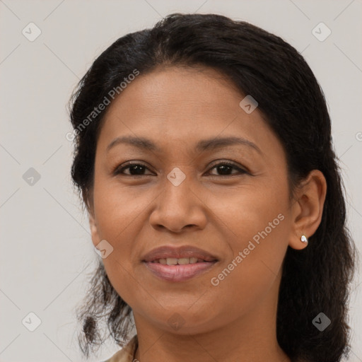 Joyful latino adult female with medium  brown hair and brown eyes