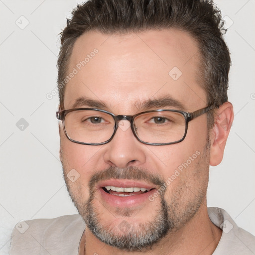 Joyful white adult male with short  brown hair and brown eyes