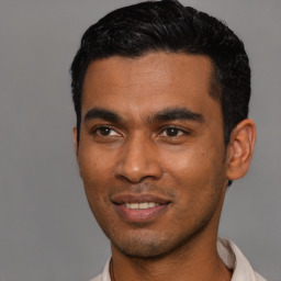 Joyful latino young-adult male with short  black hair and brown eyes