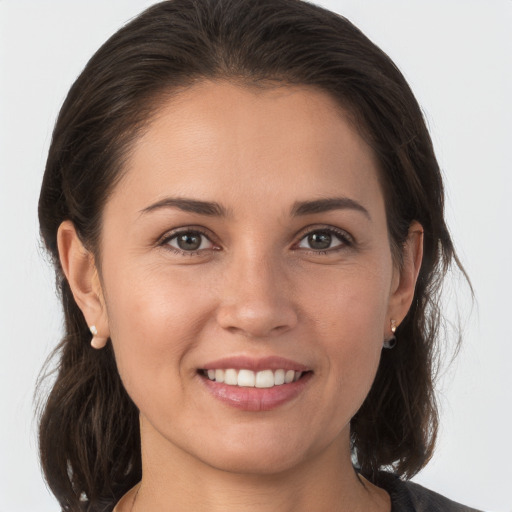 Joyful white young-adult female with medium  brown hair and brown eyes