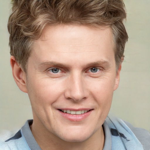 Joyful white adult male with short  brown hair and grey eyes