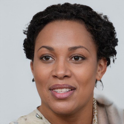 Joyful black young-adult female with short  brown hair and brown eyes
