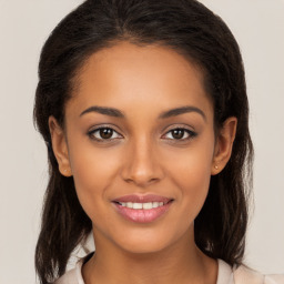 Joyful latino young-adult female with medium  brown hair and brown eyes